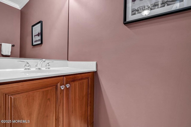 bathroom with ornamental molding and vanity