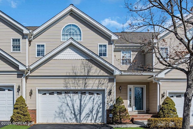 view of front of house featuring aphalt driveway and an attached garage