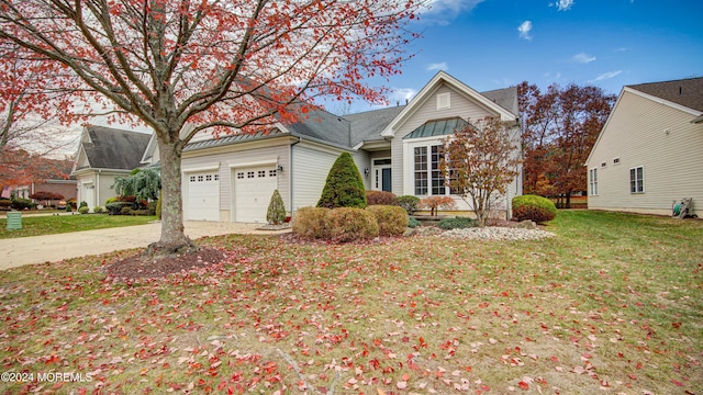 view of front facade featuring a garage, concrete driveway, and a front yard