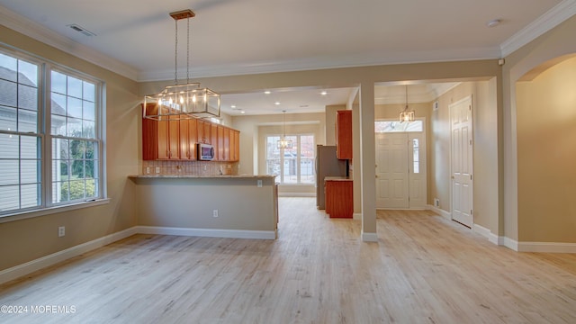 kitchen with light wood-type flooring, visible vents, appliances with stainless steel finishes, and ornamental molding