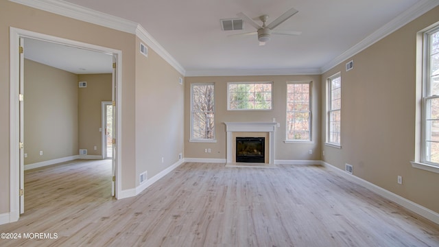 unfurnished living room with crown molding, visible vents, and light wood-style floors