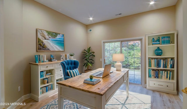 office space with recessed lighting, baseboards, visible vents, and light wood finished floors