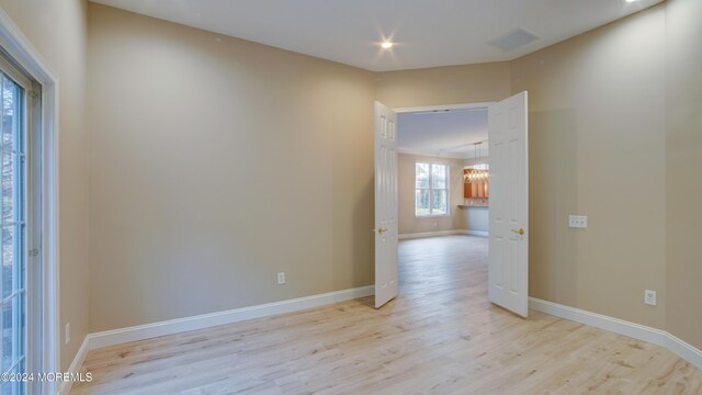 empty room with recessed lighting, light wood-type flooring, visible vents, and baseboards