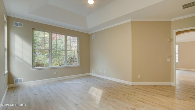 spare room with visible vents, arched walkways, and ornamental molding