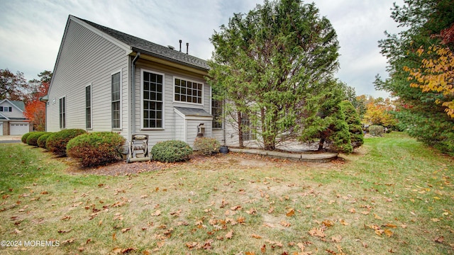 view of side of home featuring a yard