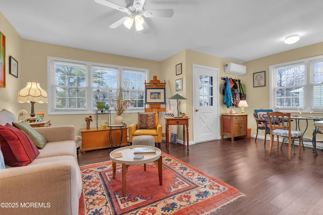 living room featuring a wall unit AC, a wealth of natural light, and wood finished floors