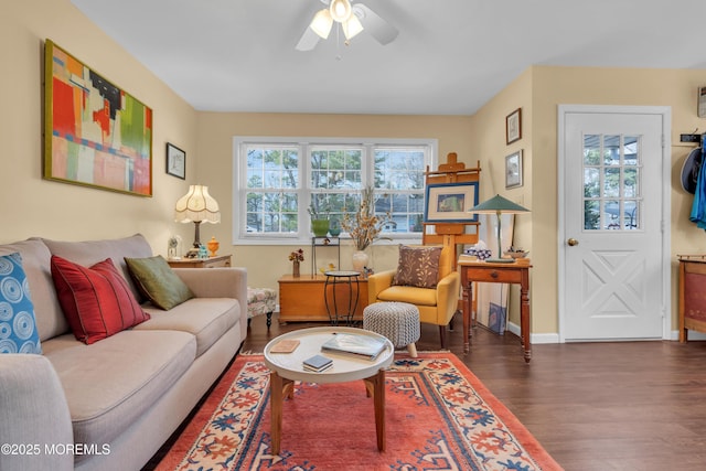 living area with ceiling fan, baseboards, and wood finished floors