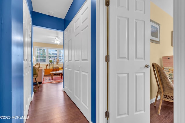 hall featuring dark wood finished floors and baseboards