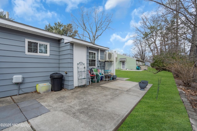 rear view of property featuring a patio and a lawn