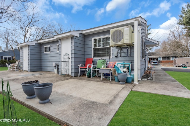 back of property featuring ac unit, a yard, and a patio