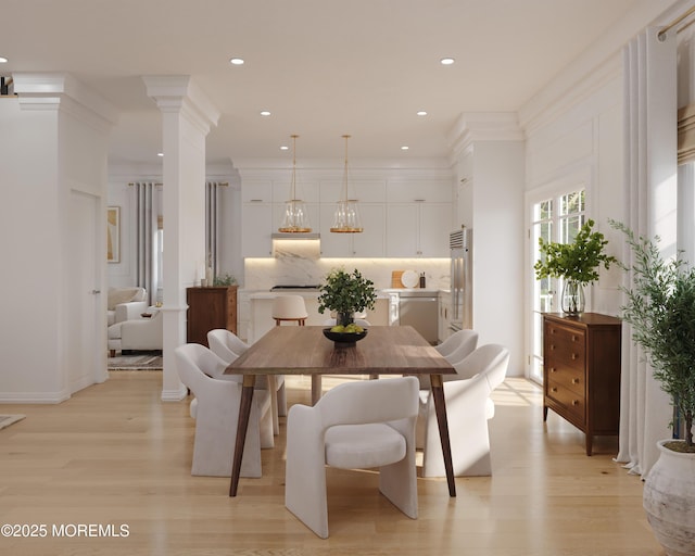 dining room featuring light wood-type flooring, decorative columns, ornamental molding, and recessed lighting