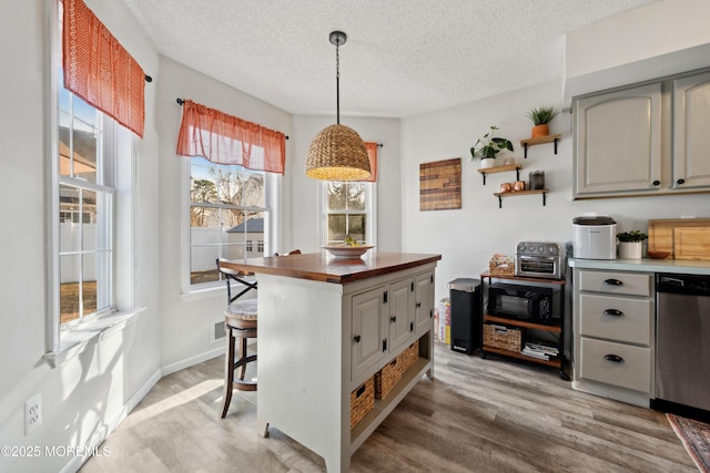 kitchen featuring gray cabinetry, dishwasher, light wood-style floors, a textured ceiling, and open shelves