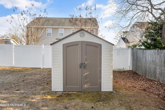 view of shed with a fenced backyard