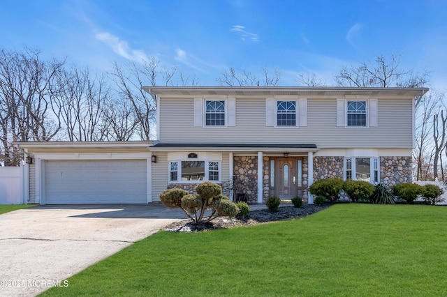 view of front of house featuring driveway, stone siding, covered porch, an attached garage, and a front yard