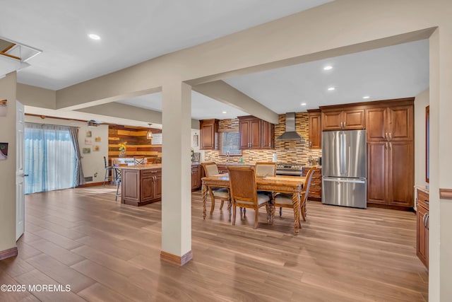 dining area with recessed lighting, light wood-type flooring, and baseboards