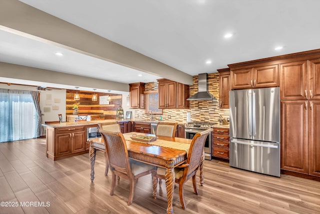 dining area featuring beam ceiling, recessed lighting, and light wood-style floors