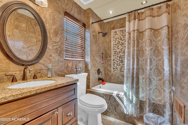 full bathroom with tiled shower / bath, toilet, tile walls, and vanity