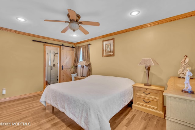 bedroom featuring baseboards, light wood finished floors, recessed lighting, crown molding, and a barn door