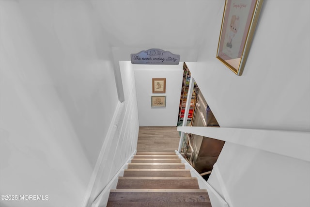 stairway with wood finished floors
