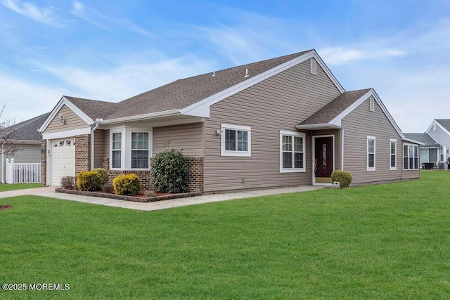 ranch-style house with an attached garage, a shingled roof, a front yard, and brick siding