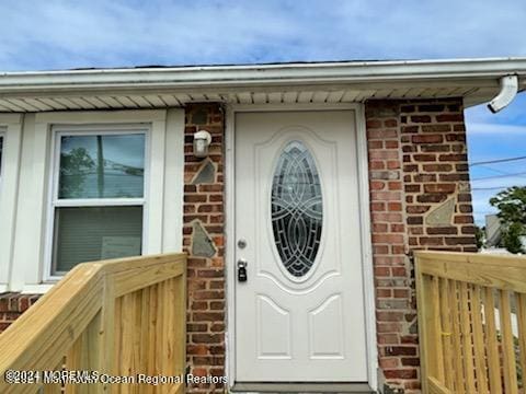 property entrance featuring brick siding