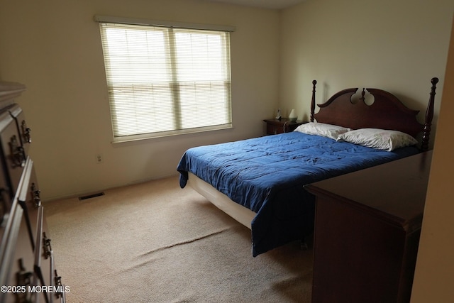 carpeted bedroom with visible vents