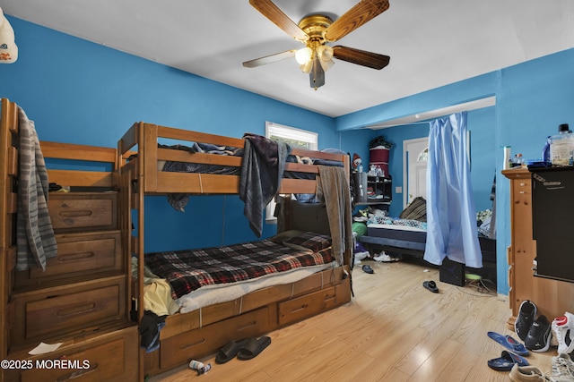 bedroom featuring a ceiling fan and wood finished floors