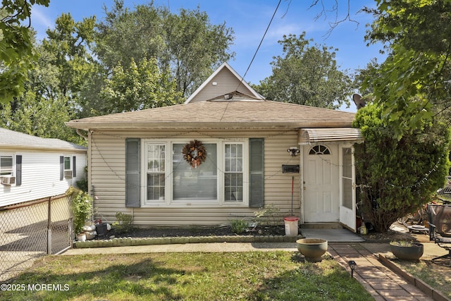 view of front of home featuring fence