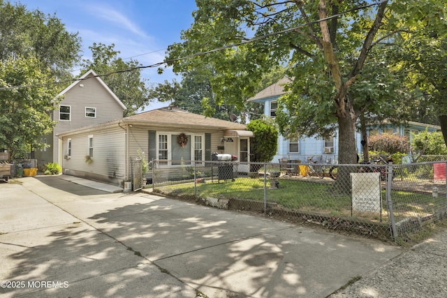 view of front of property with driveway and a fenced front yard