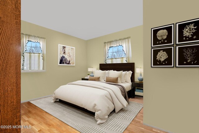 bedroom featuring light wood-style flooring and baseboards