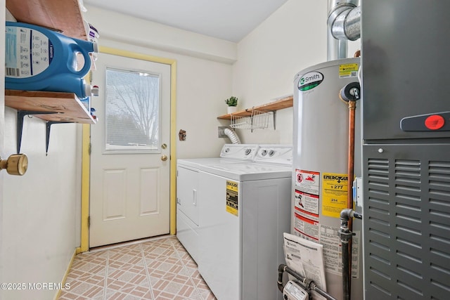 laundry area with gas water heater, independent washer and dryer, and laundry area