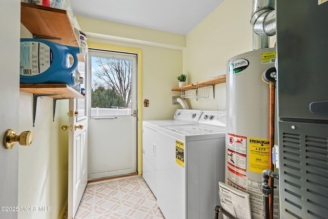 clothes washing area featuring heating unit, washer and clothes dryer, laundry area, and water heater