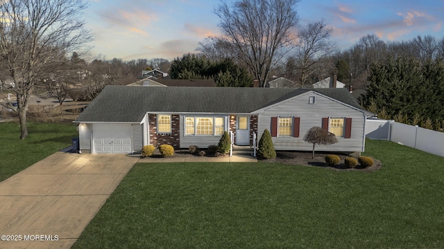 ranch-style home featuring a front lawn, fence, concrete driveway, roof with shingles, and an attached garage