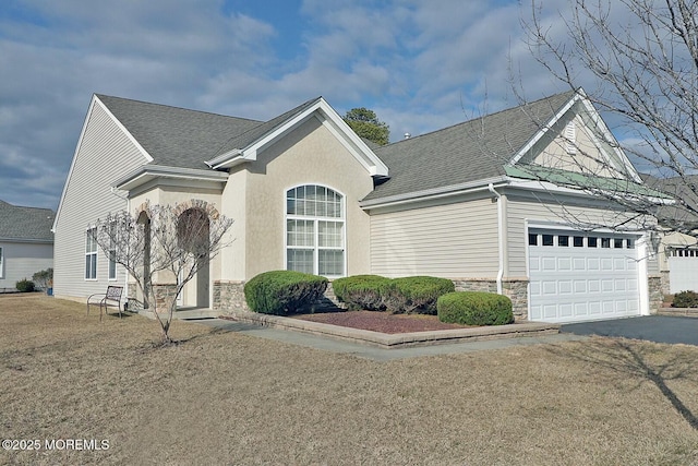 single story home with driveway, stone siding, roof with shingles, and an attached garage