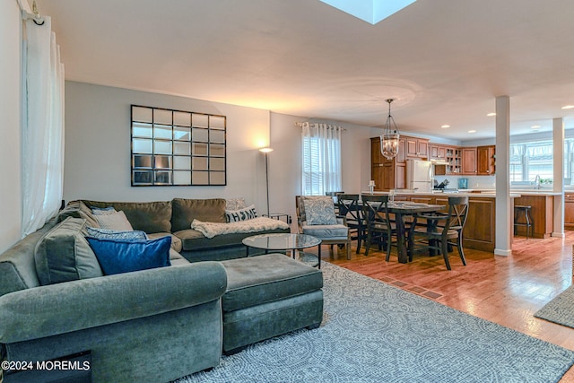 living room with light wood-style flooring and recessed lighting