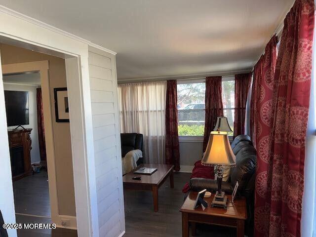 living area featuring baseboards and wood finished floors