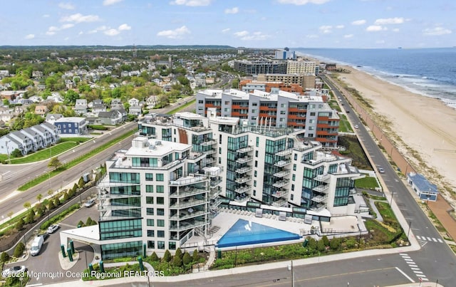 bird's eye view with a water view, a view of city, and a beach view