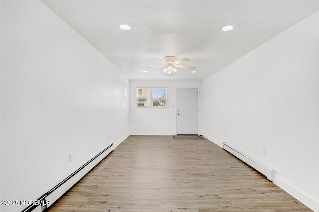 empty room featuring ceiling fan, a baseboard radiator, recessed lighting, a baseboard heating unit, and wood finished floors