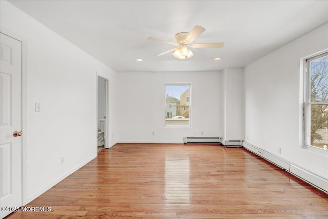 empty room with baseboards, ceiling fan, a wealth of natural light, and light wood-style floors