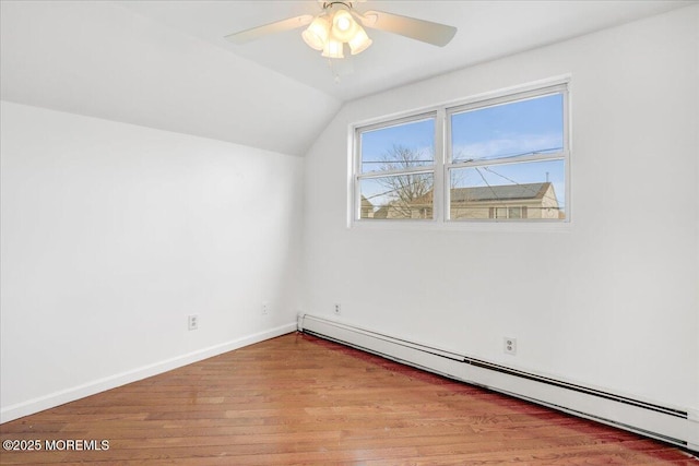 additional living space featuring baseboards, lofted ceiling, ceiling fan, light wood-type flooring, and a baseboard heating unit