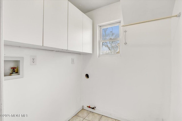 washroom featuring hookup for a gas dryer, washer hookup, cabinet space, and light tile patterned flooring