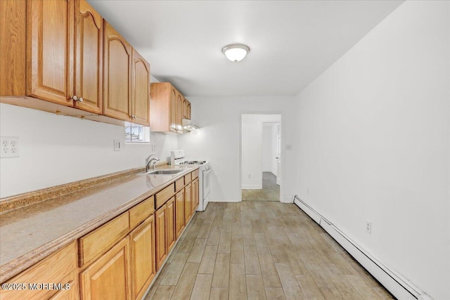 kitchen featuring light countertops, baseboard heating, light wood-style floors, a sink, and white range with gas cooktop