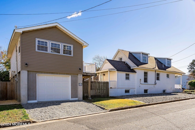 view of front of house featuring a garage and fence