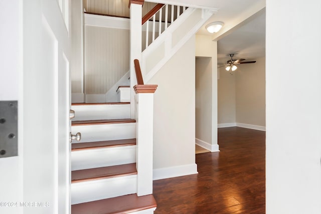 staircase featuring ceiling fan, wood finished floors, and baseboards