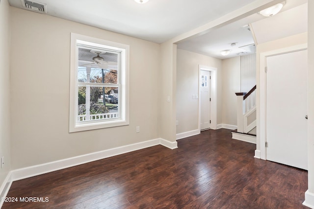 entryway featuring visible vents, stairway, baseboards, and wood finished floors