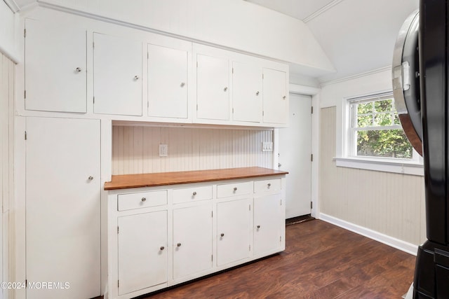 kitchen featuring dark wood-style floors, white cabinetry, vaulted ceiling, baseboards, and black fridge