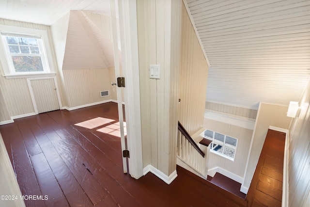 bonus room with dark wood finished floors, visible vents, and baseboards