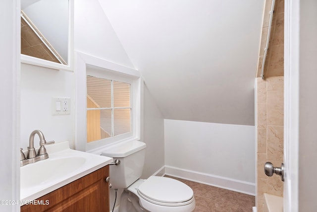 bathroom featuring tile patterned flooring, vaulted ceiling, vanity, and toilet