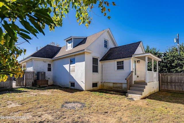 rear view of property featuring fence