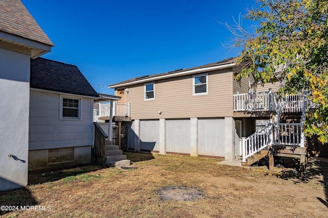 rear view of property with stairs and a deck